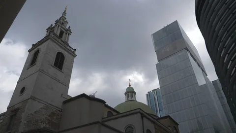Time lapse. Dark gloomy clouds over an old tower and a modern glass building. Stock Footage 107939065