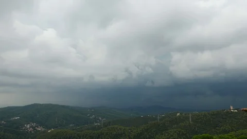 Time lapse dark heavy clouds run over sky, Barcelona mountains panorama Stock Footage 99514330