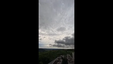 Time-lapse of dark, heavy storm clouds moving over a rolling mountain Stock Footage 331046862