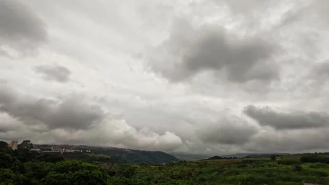 Time-lapse of dark, heavy storm clouds moving over a rolling mountain Stock Footage 331046870