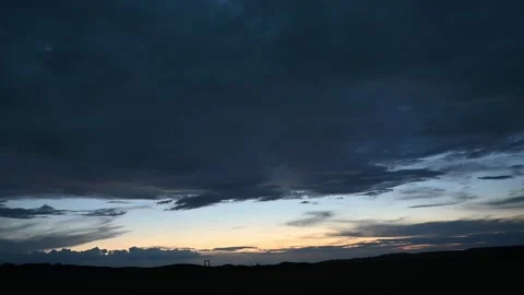 Time lapse of dark late day clouds with a layer of bright sunset sky Stock Footage 274675041