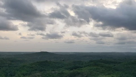 Time lapse of dark rain clouds passing above greenery. Stock Footage 114983954