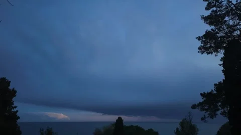 Time lapse of dark stormy clouds moving in the evening above the sea, 4K Stock Footage 266087436