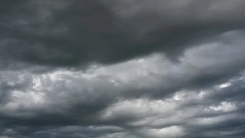 Time lapse of dark stormy clouds moving slowly through the frame. Only clouds in Stock Footage 326495976