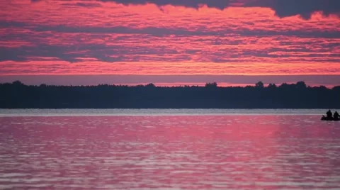 Time lapse of dawn over river with boats and ducks on water Stock Footage 67881525