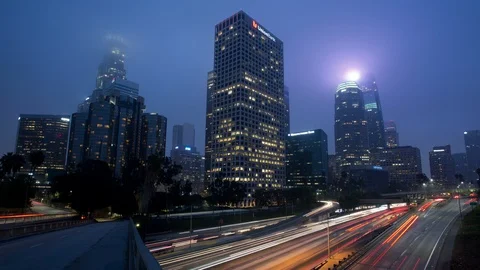 Time lapse of dawn rush hour traffic and fog shrouded skyscrapers in Los Angeles 스톡 동영상 85541262