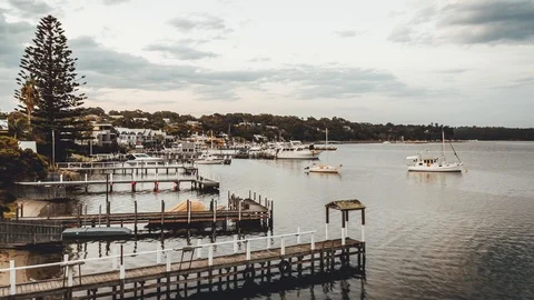 Time Lapse from day to night of lake, piers, boats and clouds Stock Footage 90979378