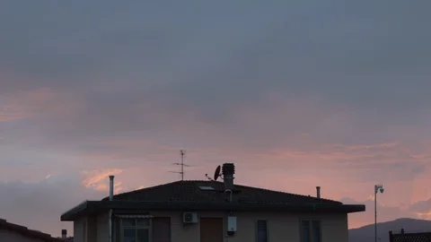 Time lapse day to night with sunset above a city house. From cloudy to sunset Stock Footage 125764143