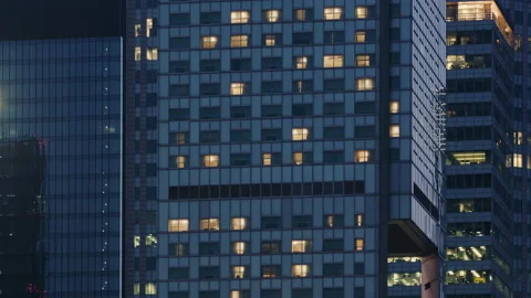 Time lapse day to night transition blinking window lights building in downtown Stock Footage 217685899