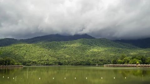 Time lapse of dense clouds moving  above mountain ranges at Huay Tung Tao Stock Footage 198778173