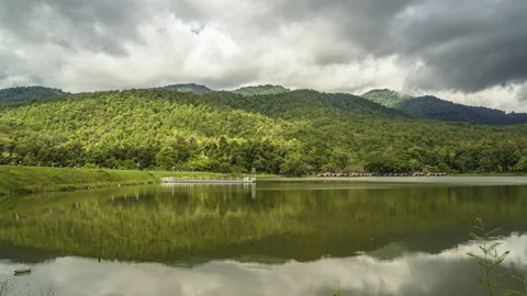 Time lapse of dense clouds moving  above mountain ranges at Huay Tung Tao Stock Footage 198778178