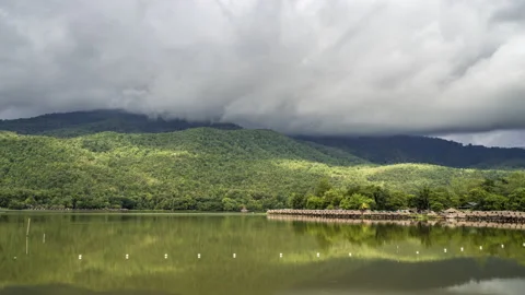 Time lapse of dense clouds moving  above mountain ranges at Huay Tung Tao Stock Footage 198779428