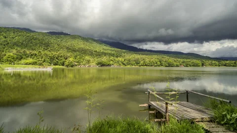 Time lapse of dense clouds moving  above mountain ranges at Huay Tung Tao Stock Footage 198780233