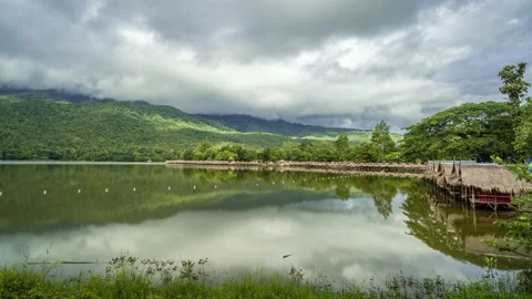 Time lapse of dense clouds moving  above mountain ranges at Huay Tung Tao Stock Footage 198780616