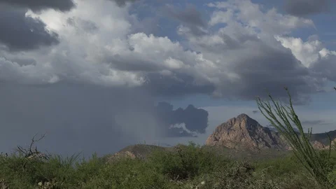 Time lapse of a desert monsoon storm near a prominent rock formation Stock Footage 113863392