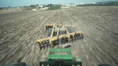Time Lapse of a disc harrow being pulled behind a tractor, shot from the rear Stock Footage 320931105