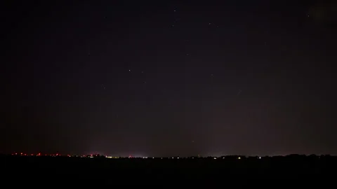 Time lapse of a distant highway at night with stars in the sky - pan Stock Footage 282345864