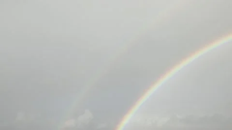 Time lapse of double rainbow forming in moving clouds Stock Footage 12163816
