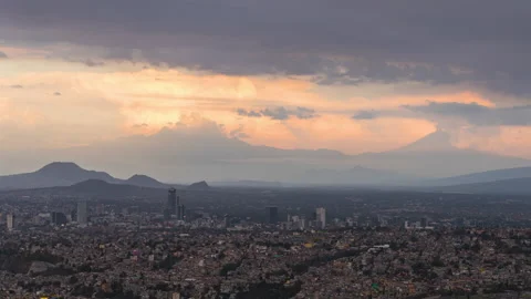 Time lapse of downtown Mexico City during sunset with Popocatepetl volcano Stock Footage