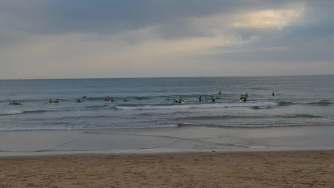Time lapse of dozens of beginners practising surfing at the frigid Atlantic Stock Footage 94659334
