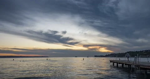 Time lapse of dramatic and colorful sunset over concrete pier Stock Footage 138089059