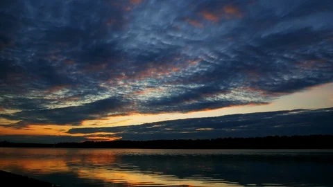 Time lapse of dramatic clouds and sunset over wide lake, landscape at evening Stock Footage 116991058