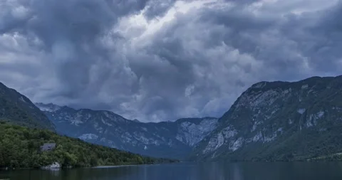 Time lapse of dramatic clouds forming in the sky over glacial lake Bohinj Stock Footage 156784426