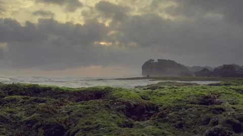 Time lapse of dramatic clouds in golden hour at Ngrumput Beach. Stock Footage 251139320