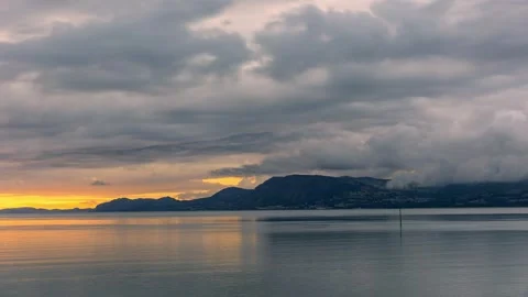 Time lapse of dramatic clouds moving across mountains at sunrise. North Wales Stock Footage 255229846