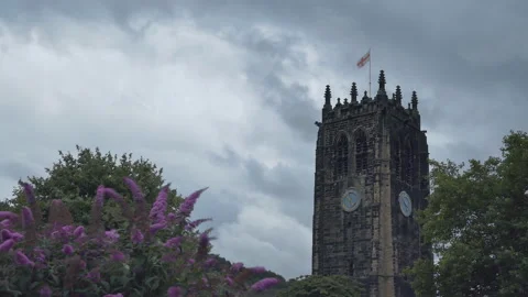 Time lapse.  Dramatic clouds over an ancient tower with the flag of England. Stock Footage 94115136