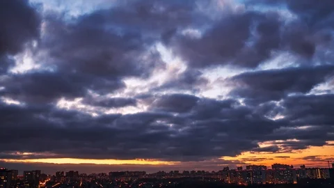 Time-lapse of dramatic clouds over evening city with burning lights Stock Footage 97836917