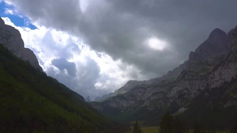 Time lapse of dramatic clouds passing over a mountain valley 4K Video stock 118086073
