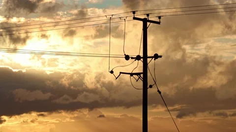 Time lapse of a dramatic cloudscape moving behind a wooden electricity pylon. UK Stock Footage 158433091