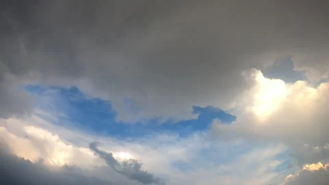 Time Lapse Dramatic Cloudscape with Sunlight Glow and Blue Sky Break 4K Stock Footage 335182187