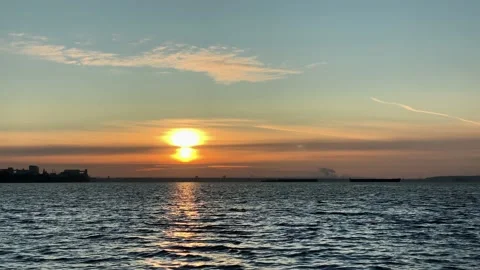 Time-lapse. Dramatic light in the sea against the backdrop of city. Beautiful Stock Footage 143379800