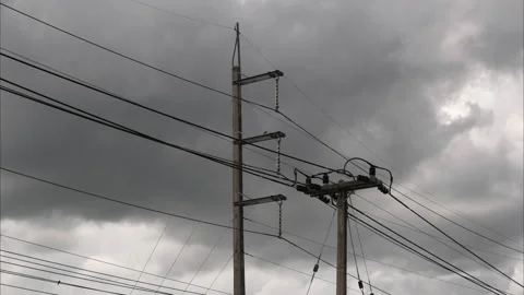 Time lapse of dramatic skies and black clouds with electric poles and wires. Stock Footage 200984034