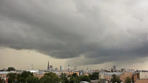 A time lapse of dramatic storm clouds rolling over a city skyline Stock Footage 52789920