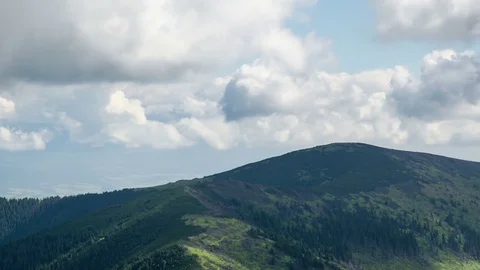 Time lapse of dramatic summer clouds and skies in magic green mountains Stock Footage 70510786