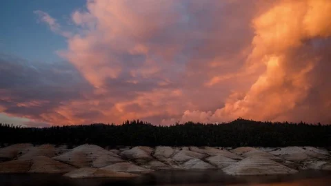 Time Lapse Dramatic Sunset Clouds Moving Over A Lake and Mountains Stock Footage 72194790