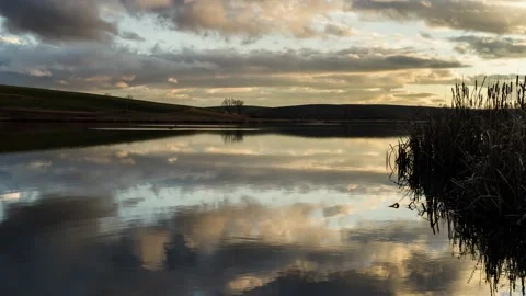 Time lapse of dramatic sunset clouds over lake, Slovakia Video stock 132349222
