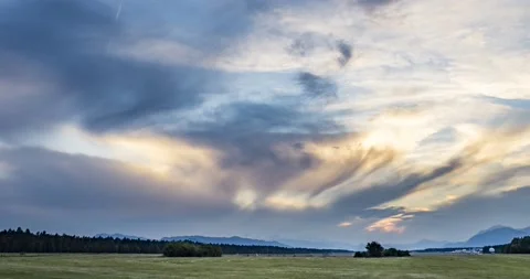 Time lapse of dramatic sunset over farming field Stock Footage 156784666