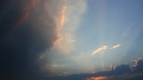 Time lapse of a dramatic white, gray and orange clouds and sun rays at sunset. Stock Footage 210221941