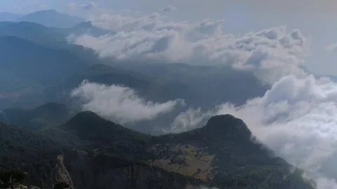 Time lapse: drifting clouds and occasional paraglider at Babadag summit Stock Footage 313225322