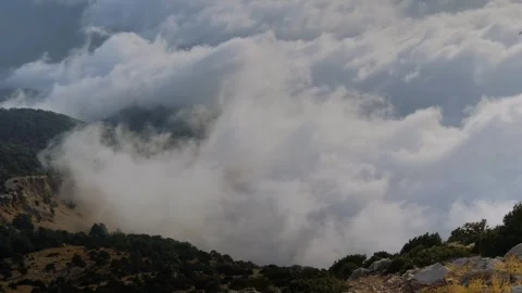Time lapse: drifting clouds and occasional paraglider at Babadag summit Stock Footage 318463377