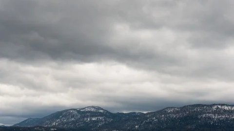 Time lapse of drifting clouds over the hills in winter. Stock Footage 89132431