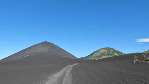 Time-lapse driving through volcano landscape. Dark black colored volcano. Stock Footage 225630469