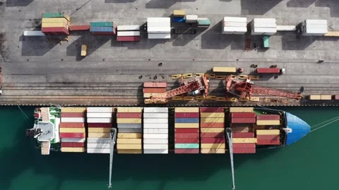 Time lapse from drone of cargo ship loading containers in industrial port Stock Footage 270290039