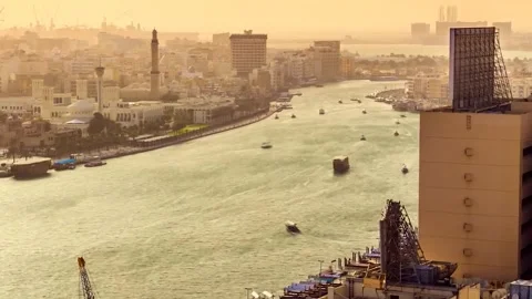 Time-Lapse of Dubai Riverfront Cityscape with Mosque at Sunset Video stock 332685365
