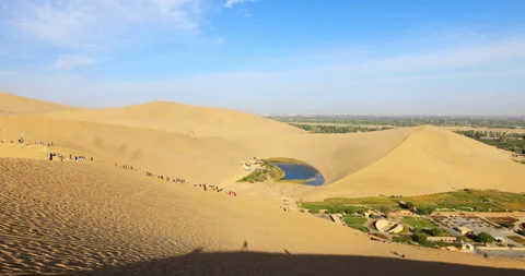 Time lapse of Dunhuang Crescent Spring and Singing Sand Mountain Stock Footage 295736388