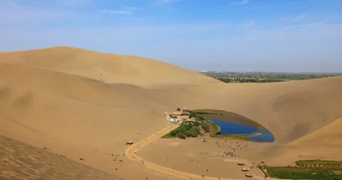 Time lapse of Dunhuang Crescent Spring and Singing Sand Mountain Stock Footage 295737247
